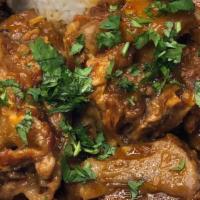 Cuban Oxtail · Cuban dish of oxtails cooked slowly with tomatoes and onions spiced with allspice, served wi...