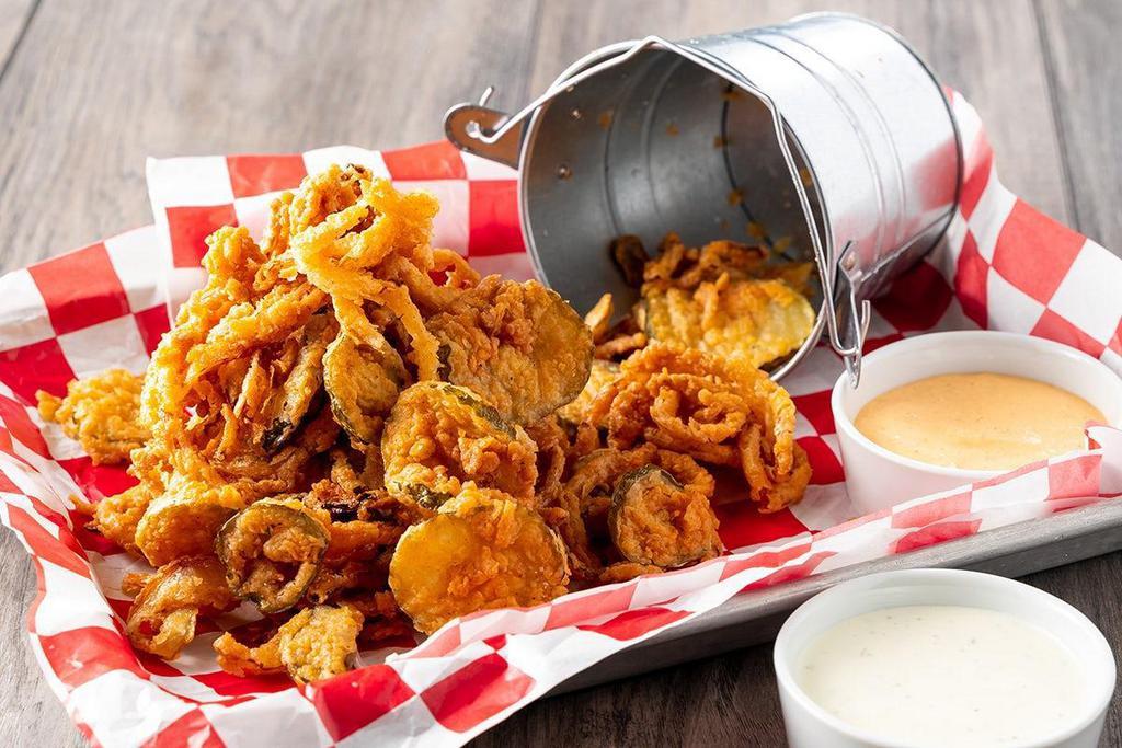 Crispy Opj Bucket · Combo of crispy onion straws, fried pickle chips and fried sliced jalapeños served with Roadhouse Ranch & Texas petal sauce.