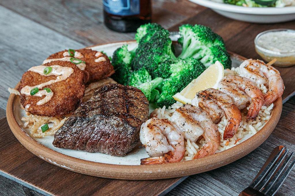 6 Oz. Sirloin Surf & Turf Trio · 6 oz. USDA Choice Sirloin, two crispy crab cakes and a skewer of mesquite-grilled shrimp over Roadhouse Rice. Served with creamy Cajun and garlic dill sauces.