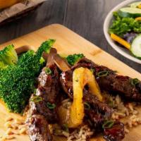 Maui Steak Skewers · Marinated steak tips over Roadhouse Rice with grilled pineapple.