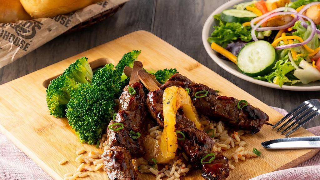 Maui Steak Skewers · Marinated steak tips over Roadhouse Rice with grilled pineapple.