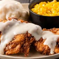 Country Style Buttermilk Chicken · Hand-breaded, all-natural chicken breasts fried & topped with white pepper gravy.