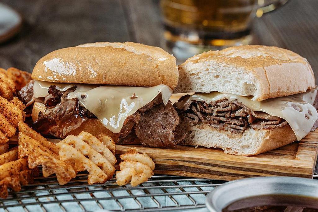 Piled High French Dip · Certified Angus Beef ®, thinly sliced in-house, dipped in hot au jus and topped with Swiss cheese on a French roll.