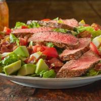 Roadhouse Steak Cobb Salad* · Mixed greens, chopped bacon, avocado, tomatoes, hard-boiled egg and croutons topped with our...