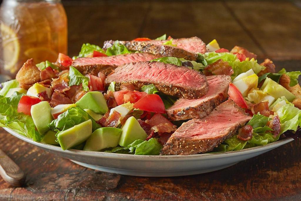 Roadhouse Steak Cobb Salad* · Mixed greens, chopped bacon, avocado, tomatoes, hard-boiled egg and croutons topped with our USDA Choice Sirloin. Served with your choice of dressing.