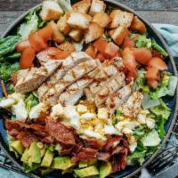 Roadhouse Grilled Chicken Cobb Salad · Mixed greens, chopped bacon, avocado, tomatoes, hard-boiled egg and croutons topped with gri...