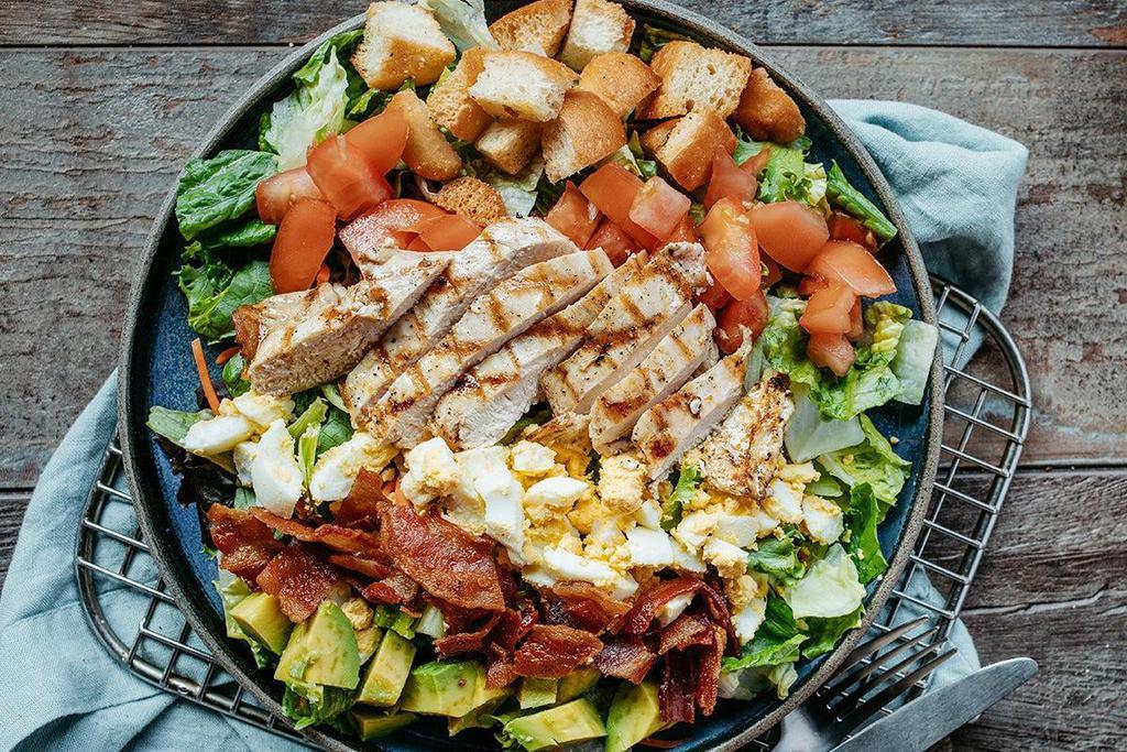 Roadhouse Grilled Chicken Cobb Salad · Mixed greens, chopped bacon, avocado, tomatoes, hard-boiled egg and croutons topped with grilled chicken. Served with your choice of dressing.