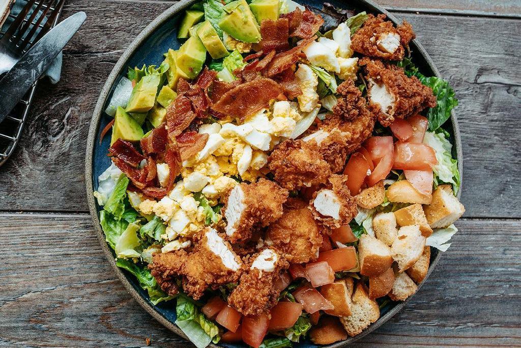Roadhouse Fried Chicken Cobb Salad · Mixed greens, chopped bacon, avocado, tomatoes, hard-boiled egg and croutons topped with fried chicken. Served with your choice of dressing.