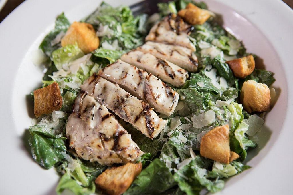 Mesquite-Grilled Chicken Caesar · Mesquite-grilled chicken smothered with our Parmesan Peppercorn dressing & served over crisp romaine lettuce tossed in creamy Caesar dressing..