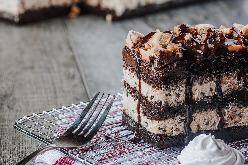 Cookie Dough Chocolate Cake · Rich chocolate cake made with layer of chocolate chip cookie dough whipped cream, topped with cookie dough pieces and drizzled with chocolate sauce.