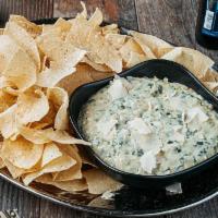 Party Pack Spinach & Artichoke Dip · A warm, creamy blend of spinach, artichokes, Swiss and Parmesan cheeses, served with tortill...