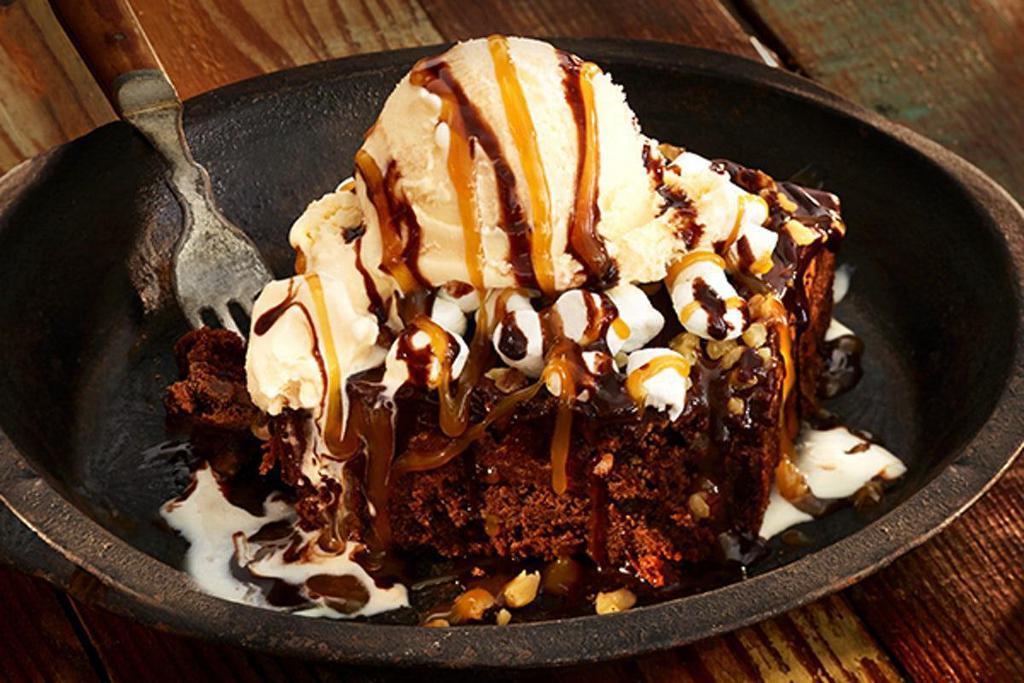 Party Pack Mississippi Brownie · Warm brownie with walnuts, marshmallows and vanilla ice cream with chocolate and caramel sauce. Serves 10-12.