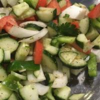 Kachumbar Salad · Chopped cucumber, bell peppers, tomatoes and onions.