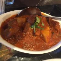 Goat Vindaloo · A spicy vinegar curry served with potatoes and goat