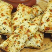 Cheese Bread (10) · Ten sticks of fresh baked bread, smothered in two types of cheese and finished with garlic b...