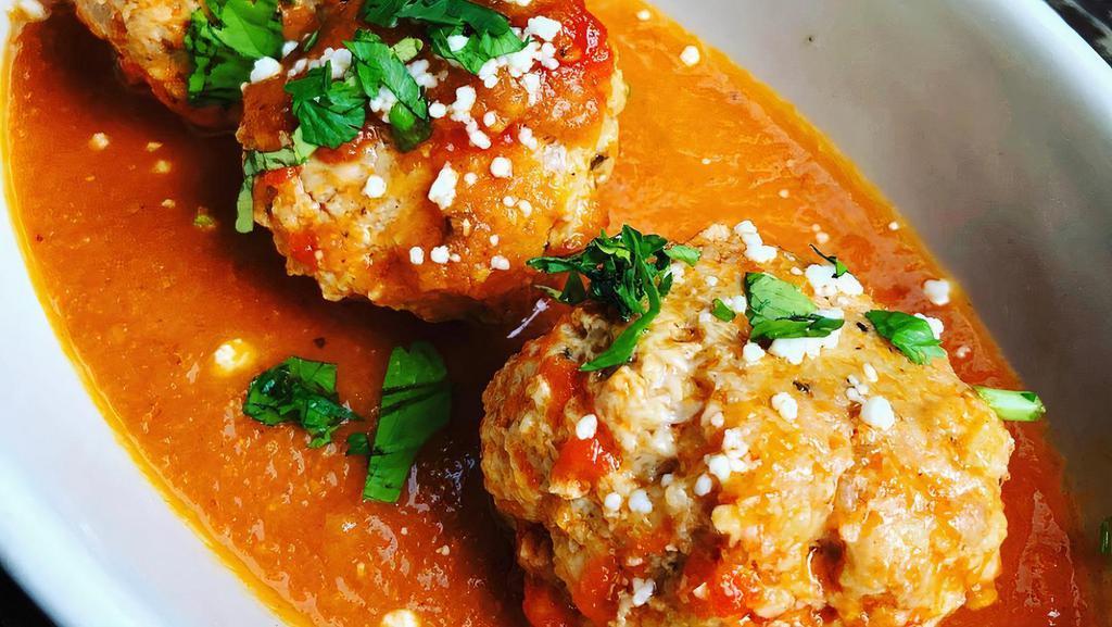 Agave Meatballs · Homemade veal, chorizo, and hatch green chile meatballs in a New Mexico red chile gravy with queso fresco and cilantro.