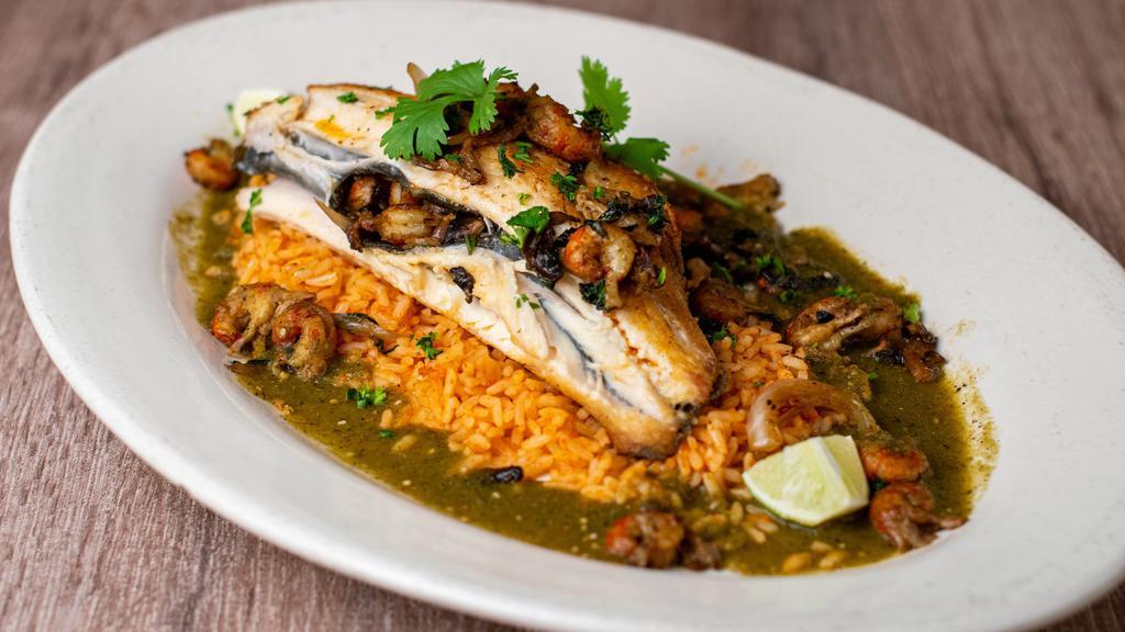 Stuffed Mountain Trout Tomatillo · Gluten free. Wild caught, fresh georgia mountain trout stuffed with crawfish, mushrooms, onions, and basil over spanish rice with a roasted tomatillo sauce and freshly cut cilantro.