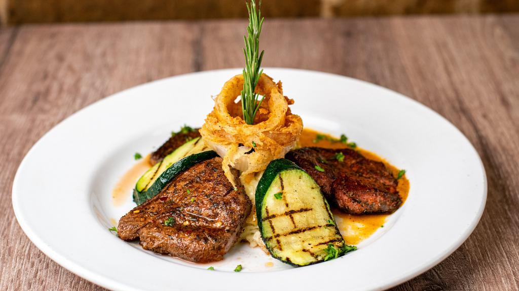 Tenderloin Medallions · Chile rubbed, center cut, fresh tenderloin filet sliced and pan-seared over a roasted tomato, garlic and chile tequila puree, accompanied by mashed potatoes, fried cayenne onions and grilled zucchini.
