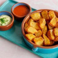 Patatas Bravas · Chunky, twice-fried potatoes, bravas sauce, garlic aioli.
