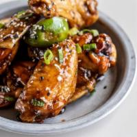 Tri-Cooked Firecracker Wings · Smoked. Fried. Tossed. . Peacan smoked wings tossed in citrus firecracker sauce, ganished wi...