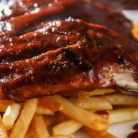 Bbq Ribs (Half Rack) · Ribs served with mac and cheese and baked beans.
