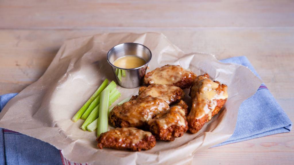 Medium-Garlic Bone-In Wings · Delicious traditional wings tossed in medium garlic sauce made to perfection and crisp.