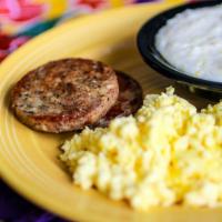 Famous Flying Biscuit Breakfast · Two eggs served with our signature chicken breakfast sausage and a side of creamy dreamy gri...