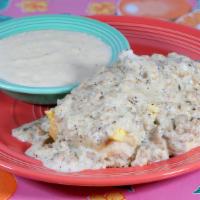 Biscuit, Eggs And Gravy Breakfast · An open-faced fluffy flying biscuit, topped with two scrambled eggs and smothered with our h...