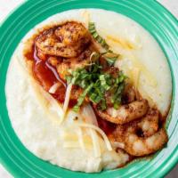Mini Shrimp And Grits · White cheddar cheese grits topped with blackened shrimp, red pepper tomato sauce and fresh b...