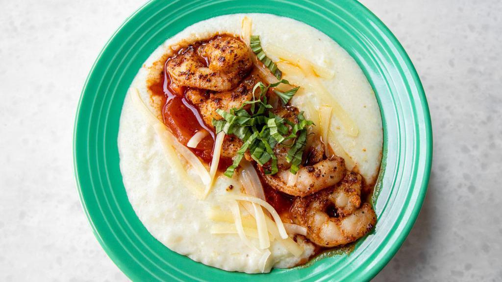 Mini Shrimp And Grits · Creamy dreamy white cheddar cheese grits topped with blackened shrimp, roasted red pepper tomato sauce and fresh basil. Served with a fluffy flying biscuit.