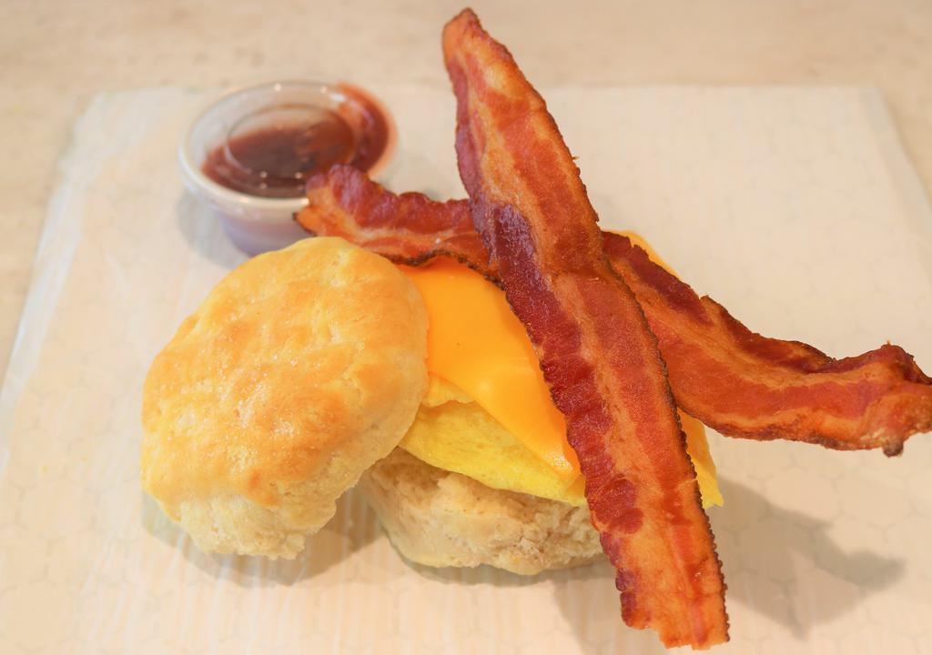 Bacon Egg And Cheese Biscuit · Biscuit sandwich with choice of turkey bacon or all-natural nitrate free applewood smoked pork bacon, scrambled egg and American cheese.
