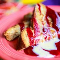 Heavenly French Toast · Thick sliced whole wheat bread topped with raspberry sauce and honey creme anglaise.