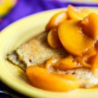 Organic Oatmeal Pancake With Peaches · Organic oatmeal pancake topped with warm peach compote.