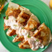Chicken Quesadilla · A buttery, golden brown quesadilla with crispy buttermilk chicken, parmesan mushrooms, white...