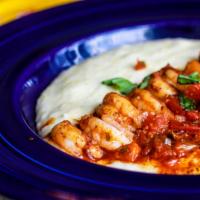 Award-Winning Shrimp And Grits · Creamy dreamy white cheddar grits topped with blackened shrimp and roasted red pepper tomato...