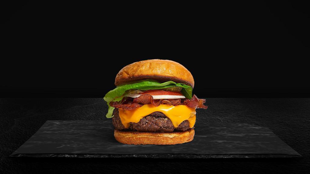 Bacon Burger · American beef patty topped with melted cheese, layers of crispy bacon, lettuce, tomato, onion, and pickles. Served on a warm bun.