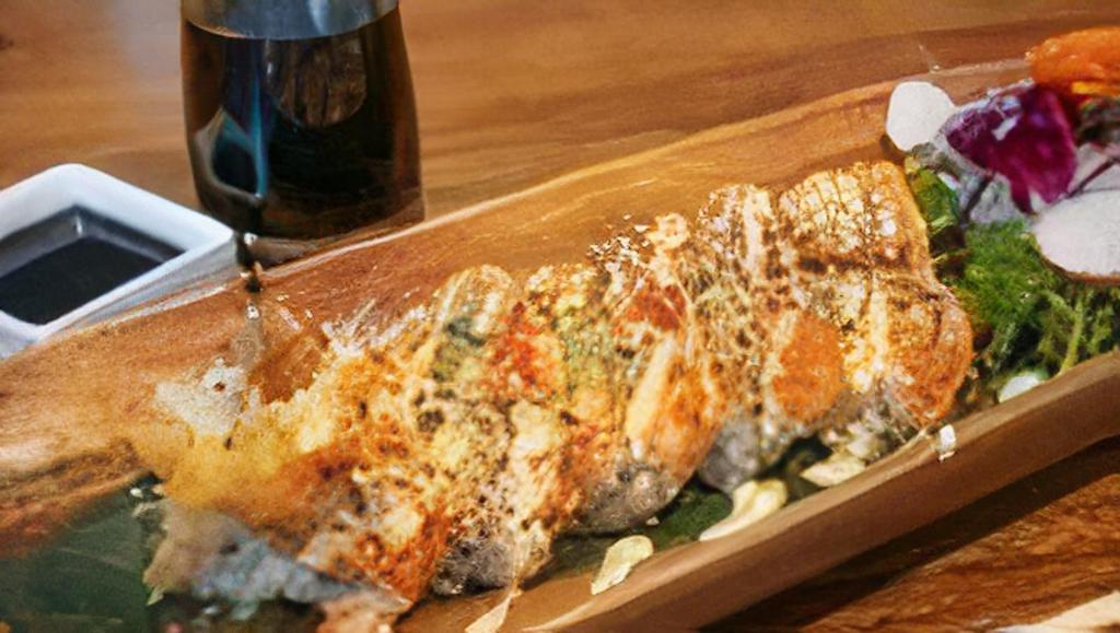 Shrimp Tempura Roll · Shrimp tempura, crab stick, avocado, spicy mayonnaise, sesame seeds, and masago topped with eel sauce.