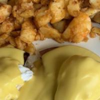 Eggs Benedict · Served with two poached eggs topped with hollandaise sauce, on a toasted English muffin. Tra...
