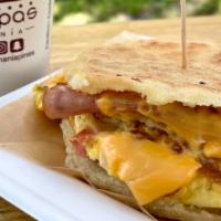 Breakfast Sandwich Arepa + Latte Combo · Made with corn flour base with yellow or white cheese, ham and scrambled eggs with onion and...