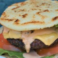 Burger Arepa · Our newest menu item! Replacing the bun we have our toasty Arepa made with corn flour, 100% ...