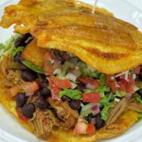 Toston Pabellón · Fried yellow plantain sandwich with your choice of skirt steak beef or chicken, avocado slic...
