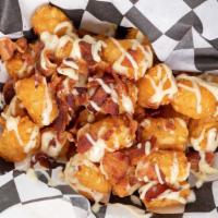 Ranch & Bacon Fries Or Tot'S · Our famous ranch wing sauce drizzled over a large fries or tots, and chopped smoky bacon.