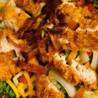 Fried Chicken Salad · Fresh iceberg lettuce, tomato, sliced onion, broccoli, fried chicken tenders, cheddar, and s...