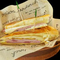 Medianoche · Thin slices of ham + pork + Swiss cheese + pickles + mustard + sweet bread
