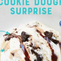 Cookie Dough Surprise · Birthday Cake Ice Cream, Cookie Dough, Oreo® Cookie Pieces & Fudge Topping.