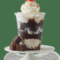 Fudge Brownie Sundae · Vanilla Ice Cream with fudge brownie pieces and fudge, topped with whipped cream, chopped pe...