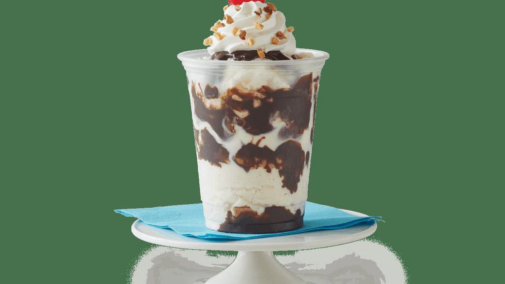 Classic Sundae · Vanilla ice cream with choice of fudge or caramel, topped with whipped cream, chopped peanuts, and a cherry.