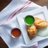 Vegetable Samosas · 2 pieces. Triangular puffed pastry stuffed with cubed potatoes, green peas, carrots, and mil...