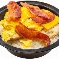 Bacon Egg & Cheese Biscuit Grits · Bowl of made-from-scratch grits loaded with a buttery biscuit, bacon, scrambled eggs, and ch...