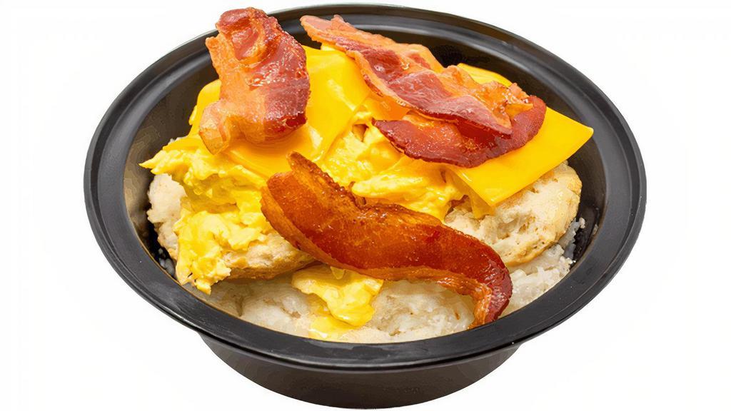 Bacon Egg & Cheese Biscuit Grits · Bowl of made-from-scratch grits loaded with a buttery biscuit, bacon, scrambled eggs, and cheese.